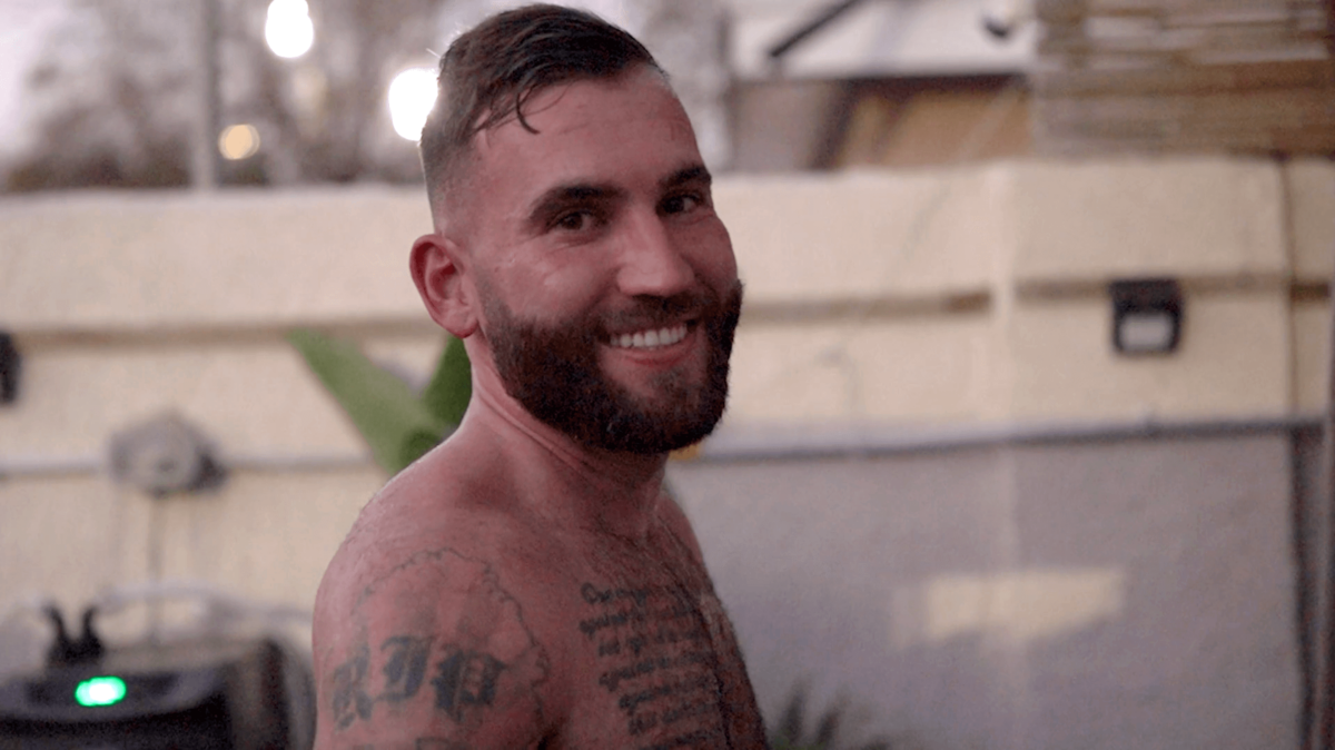 man with wet hair smiling at camera