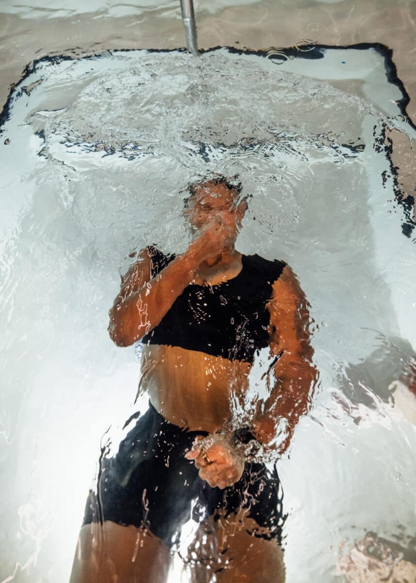 A Revivery member regulating her breath during a guided cold plunge